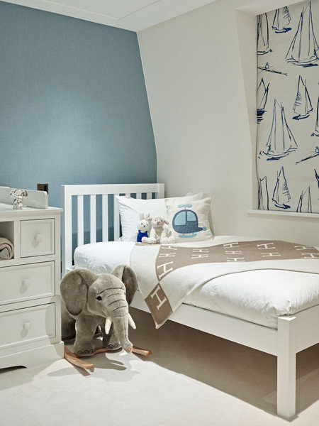 A whimsical sailboat patterned shade adds character in a sophisticated way to a child's room designed