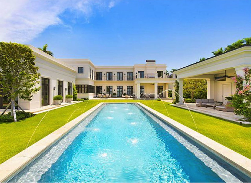 This outdoor space designed by Fernando Wong bears clean-lined manicured lawns surrounding the pool,