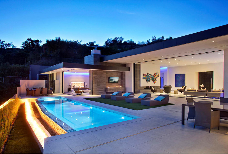 The home's BBQ area includes an outdoor television—just one of the home's many screens.