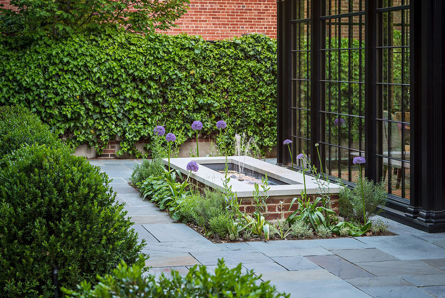 In this garden designed by Jennifer Horn, the water features’ base is planted with evergreen perennia