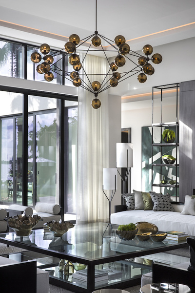 A contemporary cluster of illuminated orbs becomes the dramatic focal point of a living room designed